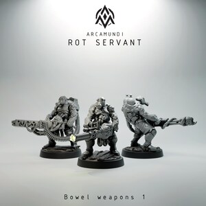 May include: Three gray miniature figures of armored characters with gas masks and large weapons. The figures are on black bases. The text "Arcamundi Rot Servant" and "Bowel weapons 1" are also visible.