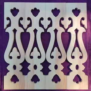 May include: Four unfinished wooden panels with decorative cut-out designs. The panels feature repeating patterns of curved lines, heart shapes, and floral-like elements. The wood has a natural, light color, and the background is a solid purple.