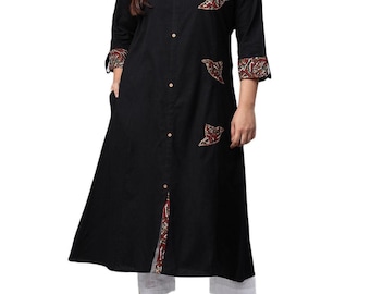 May include: Black long tunic with a mandarin collar and three-quarter sleeves. The tunic features decorative patterned patches in red, brown, and cream. The cuffs and a front panel also have the same patterned fabric. The tunic is buttoned down the front.