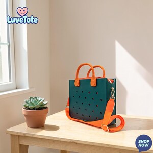 May include: A teal tote bag with orange handles and a matching shoulder strap sits on a wooden table. The bag has a perforated design and a zipper closure. A small potted succulent is next to the bag. The Luvetote logo is in the upper left corner.