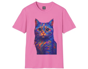 May include: A pink t-shirt featuring a colorful illustration of a cat. The cat's fur is a mix of blue, orange, and yellow, with large blue eyes. The shirt has a crew neck and short sleeves.