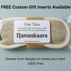 May include: A beige sleep mask with a burlap texture, packaged in clear plastic. The mask has a white border and a label that reads "For You" with the brand name "Namaskaara". Text at the top says "FREE Custom Gift Inserts Available".