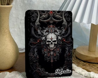 May include: Black tablet case featuring a detailed skull design with ornate, gothic-style embellishments in shades of gray and red. The name "Marlia" is scripted on the lower right. The text "CUSTOM YOUR NAME" is at the bottom.