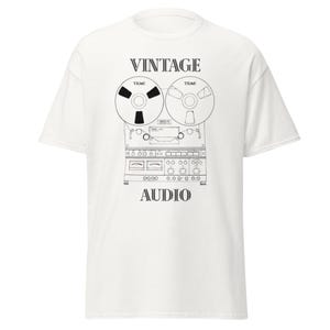 May include: White t-shirt with a black and white illustration of a vintage reel-to-reel tape recorder. The words "VINTAGE" and "AUDIO" are printed above and below the graphic.