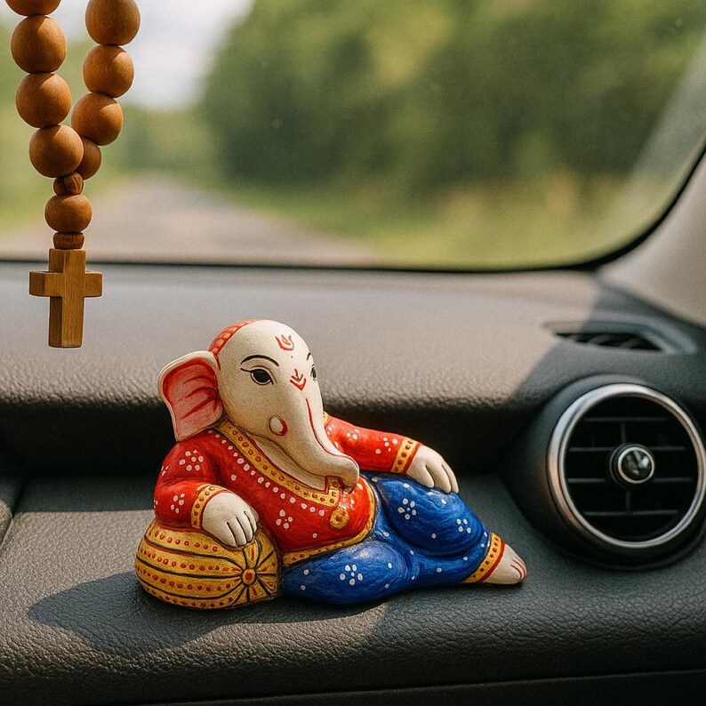 ganesha idol car dashboard lying ganpati murti spiritual decor