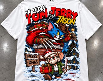 May include: A white t-shirt featuring a graphic print of Tom as Freddy Krueger emerging from a chimney and Jerry as Jason Voorhees holding a knife and a gift. The text reads FREDDY TOM vs JERRY JASON and MERRY XMAS on a wooden sign.