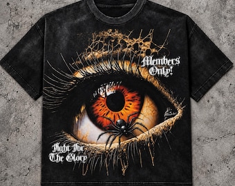 May include: A black short-sleeve t-shirt featuring a large, detailed graphic of an orange and brown human eye with a black spider resting on the iris. The text "Members Only!" and "Fight for The Glory" is printed in a white gothic font.