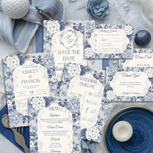 May include: A collection of blue and white floral wedding stationery, including invitations, RSVP cards, and a menu. The designs feature elegant floral patterns and text such as "Save the Date" and "Ashley & Francis".