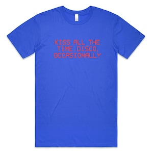 May include: A royal blue t-shirt with the text "KISS ALL THE TIME DISCO, OCCASIONALLY" in red. The shirt has a crew neck and short sleeves. The text is centered on the front of the shirt.