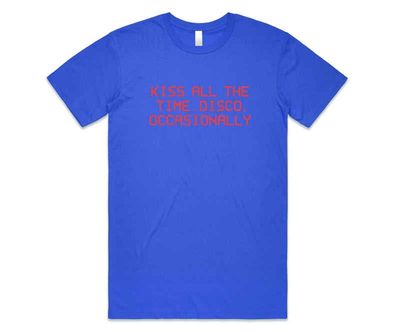 May include: A royal blue t-shirt with the text "KISS ALL THE TIME DISCO, OCCASIONALLY" in red. The shirt has a crew neck and short sleeves. The text is centered on the front of the shirt.