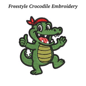 May include: Green embroidered crocodile with a red bandana, smiling and giving a thumbs-up. The design features a yellow belly and black outlines. Text above reads "Freestyle Crocodile Embroidery".