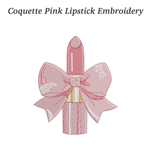 May include: Embroidered design of a pink lipstick with a large pink bow. The text "Coquette Pink Lipstick Embroidery" is at the top. The lipstick has a gold-colored base and a pink bow tied around it.