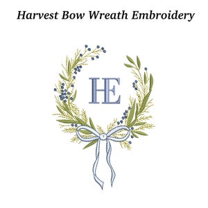 May include: An embroidered wreath design with the text "Harvest Bow Wreath Embroidery" at the top. The wreath features green leaves, blue berries, and a light blue bow. Inside the wreath are the letters "HE" in blue.