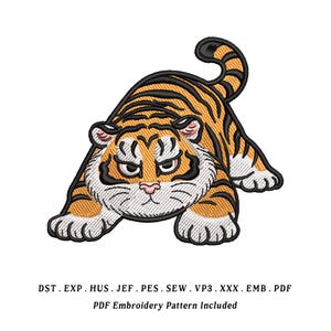 May include: An embroidered tiger design in orange, black, and white, with an angry expression. The tiger is in a crouching position, with its paws extended. The text at the bottom says "PDF Embroidery Pattern Included".