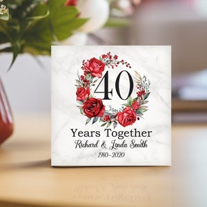 May include: A white marble square tile with a red floral wreath and the number 40 in the center. The text "Years Together" is below the wreath, followed by "Richard & Linda Smith" and "1980-2020".