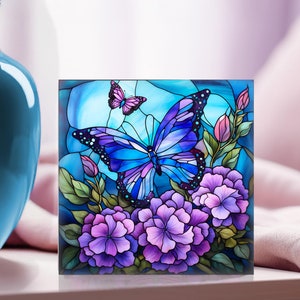 May include: A stained glass style artwork featuring a blue butterfly with purple flowers and a smaller butterfly in the background.