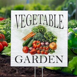 May include: A white wooden sign with the text "VEGETABLE GARDEN" in black lettering. The sign features a colorful illustration of a variety of fresh vegetables, including tomatoes, peppers, cucumbers, onions, and carrots.