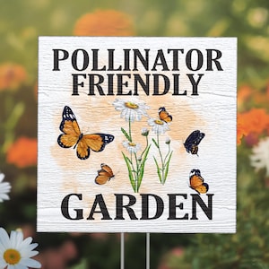 May include: White wooden sign with the text "Pollinator Friendly Garden" in black lettering. The sign features a watercolor-style background with daisies and butterflies.