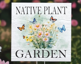 May include: White wooden sign with the text "NATIVE PLANT GARDEN" in black lettering. The sign features a watercolor illustration of a bouquet of pink and yellow flowers with butterflies in shades of blue, orange, and red.