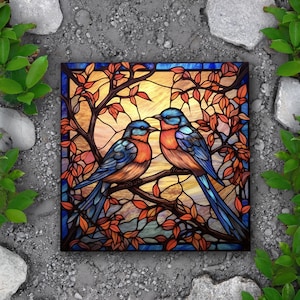 May include: Two bluebirds with orange and brown markings are perched on a branch with red and orange leaves. The birds are depicted in a stained glass style with a colorful background.