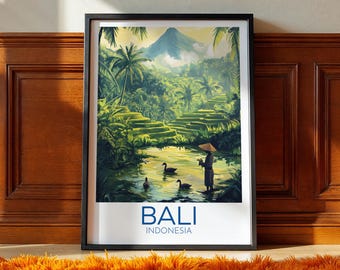 May include: A framed art print depicting a serene Bali landscape. The artwork showcases a lush green rice terrace, a river with ducks, and a figure in traditional attire. The word "BALI" and "INDONESIA" are printed at the bottom.