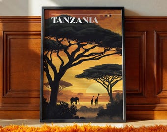 May include: Framed art print featuring a sunset scene in Tanzania. The artwork depicts silhouetted trees, an elephant, and giraffes against a vibrant orange and yellow sky. The word "TANZANIA" is printed at the top.