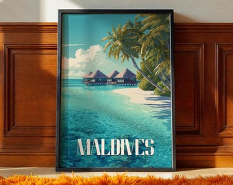 May include: A framed art print featuring a tropical beach scene in the Maldives. The artwork depicts overwater bungalows, palm trees, and turquoise water under a blue sky. The word "MALDIVES" is displayed in white block letters.