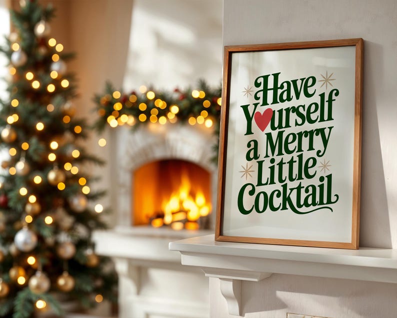 May include: A framed print with the text "Have Yourself a Merry Little Cocktail" in green and red, displayed on a white mantel. A Christmas tree with gold ornaments and lights is in the background, along with a fireplace.