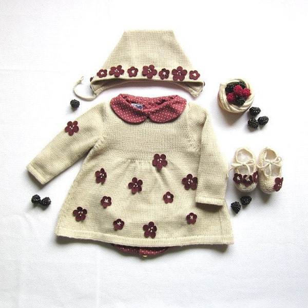 A knitted baby dress full of little flowers. 100% wool. Newborn