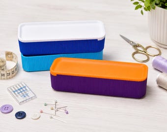 Multi-purpose storage box with removable tray for everyday organization.
