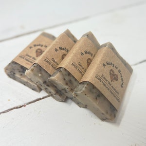 May include: Four bars of brown soap with a brown paper label that says "A Baby is Brewing" and "Savor the moment! 100% Natural Handmade".