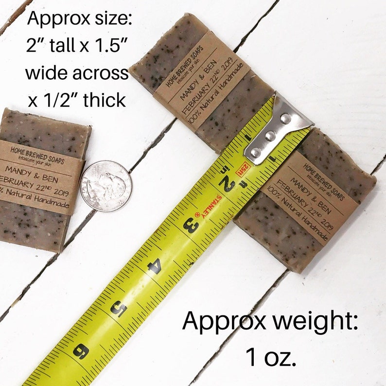 May include: Two brown and black soap bars with a label that reads "Home Brewed Soaps" and "Mandy & Ben" with the date "February 22nd 2019" and "100% Natural Handmade". The soap bars are measured with a yellow tape measure. The soap bars are approximately 2 inches tall, 1.5 inches wide, and 1/2 inch thick. The soap bars weigh approximately 1 ounce.