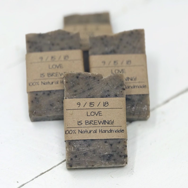 May include: Four brown bars of soap with brown paper labels. The labels have the text "9/15/18 Love is Brewing! 100% Natural Handmade".