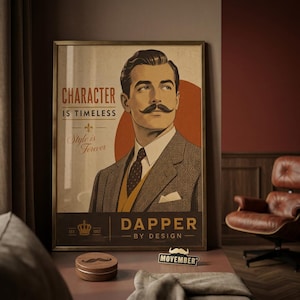 May include: A framed poster featuring a vintage-style illustration of a man with a mustache wearing a suit and tie. The text reads: CHARACTER IS TIMELESS, Style is Forever, DAPPER BY DESIGN, and EST. 1957. A small wooden box and a Movember sign are below.