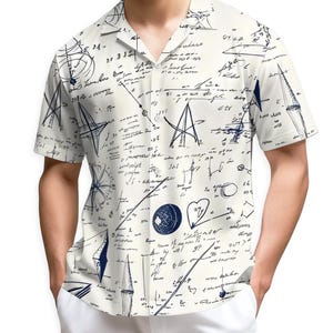 May include: Short-sleeved button-down shirt with a cream-colored background and a navy blue abstract design. The design includes sketches of geometric shapes, lines, and handwritten text. The shirt has a classic collar and a relaxed fit.