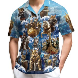 May include: Short-sleeved button-down shirt with a blue sky and ocean background. The shirt features a repeating pattern of cats dressed as Viking warriors, riding horses and boats, and holding swords and shields.