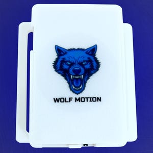 May include: White rectangular product with a blue wolf head logo and the text "WOLF MOTION" on a blue background. The wolf head is detailed with sharp teeth and intense eyes.