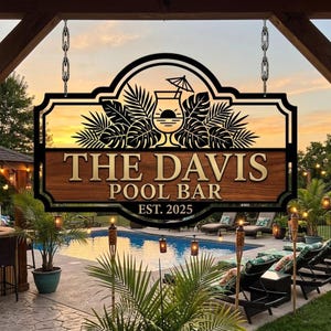 May include: A custom metal sign for a pool bar, featuring the text "THE DAVIS POOL BAR" and "EST. 2025". The sign has a tropical design with a cocktail and palm leaves, hanging by chains. The background shows a pool and sunset.