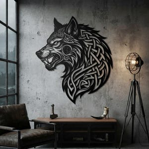 May include: A black metal wall art piece shaped as a wolf head in profile, featuring intricate Celtic knotwork patterns throughout the design. The wolf is depicted with an open mouth showing sharp teeth, rendered in a flat, matte black finish.