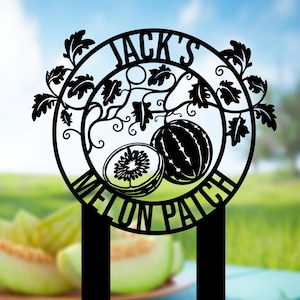 May include: Black metal sign with the text "JACK'S MELON PATCH" in a circular design. The sign features a whole watermelon and a sliced melon, with decorative vines and leaves. The sign has two stakes for easy placement.