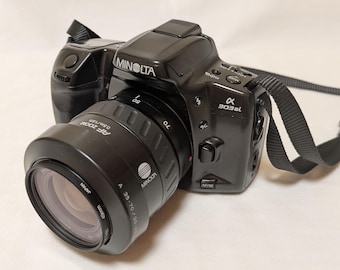 Minolta a 303si 35mm Film SLR Camera with AF Zoom Lens 35-70mm F3.5-4.5, Hood, Cap, Kenko Sky Light, and Manual
