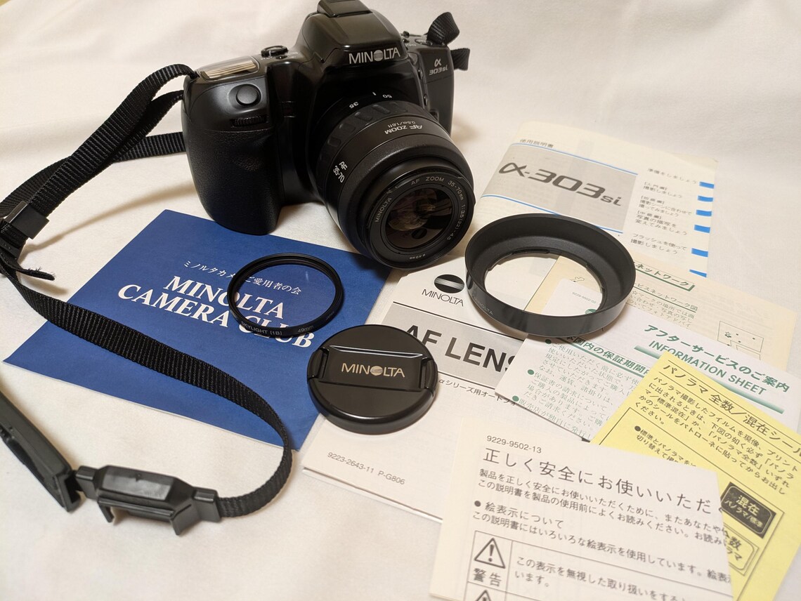 Minolta a 303si 35mm Film SLR Camera with AF Zoom Lens 35-70mm F3.5-4.5, Hood, Cap, Kenko Sky Light, and Manual, photo 2 sur 5