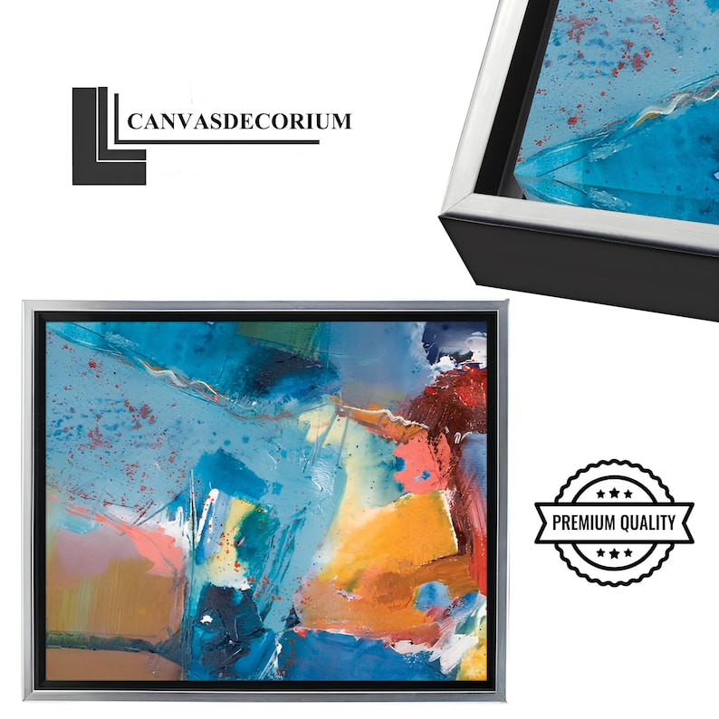 Puede incluir: Impresi&oacute;n en lienzo de arte abstracto con marco plateado. La obra presenta una vibrante mezcla de colores, incluyendo azules, naranjas y rosas. El lienzo est&aacute; etiquetado con el texto "CANVASDECORIUM" y un sello "PREMIUM QUALITY".