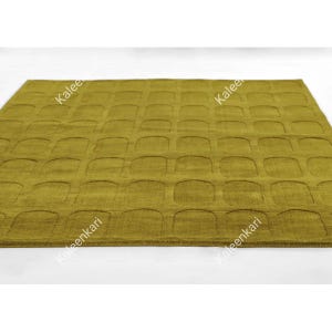 May include: A rectangular area rug in a solid olive green color featuring a repeating grid pattern of recessed, rounded square shapes across the entire surface. The word Kaleenkari is printed in white text diagonally across the rug.