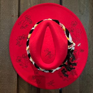 Red wide brim felt fedora with custom, hand burned design of poppies with braided band
