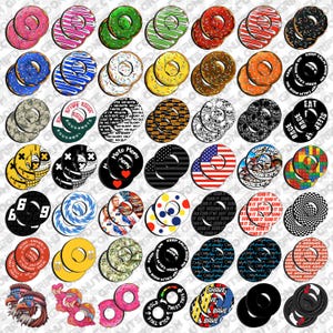 May include: A collection of colorful donut-shaped grip tape designs. The designs include various patterns, text, and graphics, such as the American flag, skulls, and the words "Moto Moms." These grip tapes are likely for skateboards or similar equipment.
