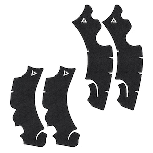May include: A set of six black, textured grip pads. Each pad has a unique shape with curved edges and a white triangle logo. The pads are designed to provide enhanced grip and control.