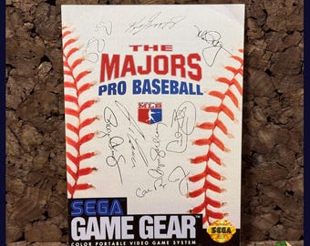 May include: A Sega Game Gear cartridge for "The Majors Pro Baseball" video game. The cover features a baseball design with red stitching and the game title in red and blue. Includes the MLB logo and player signatures.