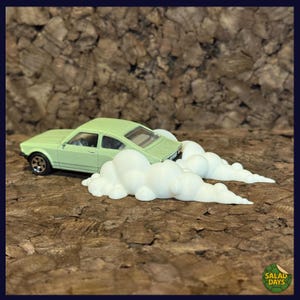 May include: A light green toy car with black wheels and a white cloud effect. The car is positioned as if it is speeding, with the cloud effect trailing behind it. The background is a textured brown surface.