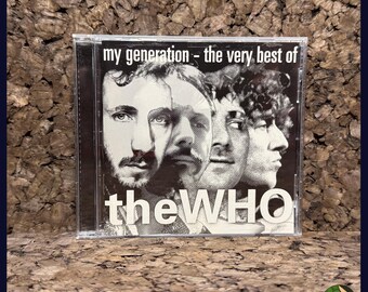 May include: CD case for "My Generation - The Very Best Of The Who." The album cover features a black and white image of the band members' faces. The band's name, "the WHO," is printed in white.